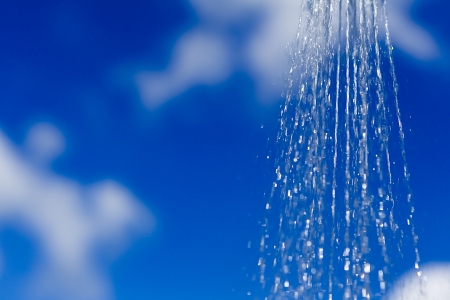 shower sprinkler on blue sky の写真素材