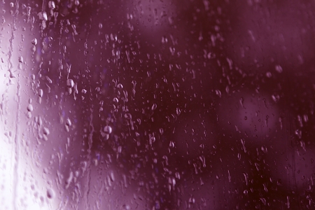 natural water drops on window glass with purple background の写真素材