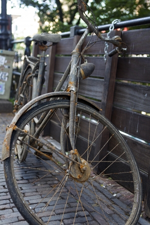 old bike by the fenceの写真素材