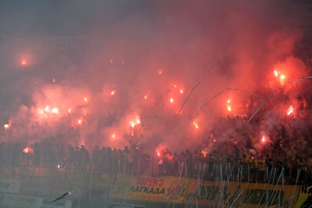 THESSALONIKI, GREECE - AUGUST 5, 2009: Fans of Aris team light flares in football match between Aris and Boca Juniors cheering for their team goals のeditorial素材