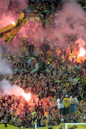 THESSALONIKI, GREECE - AUGUST 5 ,2009: Fans of Aris team light flares in football match between Aris and Boca Juniors cheering for their team goals のeditorial素材