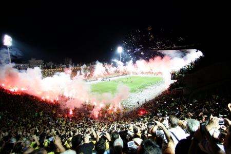 THESSALONIKI, GREECE - AUGUST 5, 2009: Fans and supporters of Aris team light flares in football match between Aris and Boca Juniors cheering for their team goalsのeditorial素材