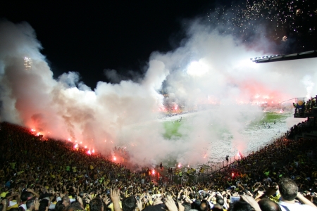 THESSALONIKI, GREECE - AUGUST 5, 2009: Fans and supporters of Aris team light flares in football match between Aris and Boca Juniors cheering for their team goalsのeditorial素材