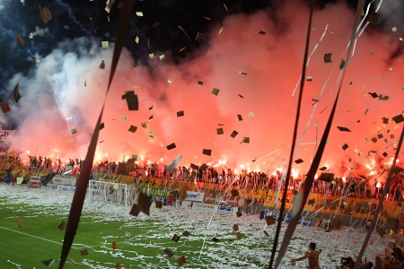 THESSALONIKI, GREECE - AUGUST 5, 2009: Fans and supporters of Aris team light flares in football match between Aris and Boca Juniors cheering for their team goals のeditorial素材