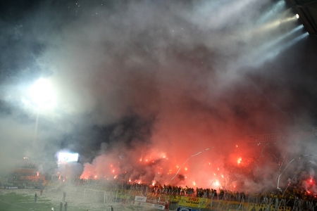 THESSALONIKI, GREECE - AUGUST 5, 2009: Fans and supporters of Aris team light flares in football match between Aris and Boca Juniors cheering for their team goals のeditorial素材