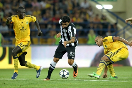 KHARKIV, UKRAINE -AUG 07:Athanasiadis of PAOK (R) in action with Gueye of METALIST (L) during the UEFA Champions League soccer match METALIST vs PAOK at Metalist Arena on August 07,2013 in Kharkiv, Ukraine.のeditorial素材