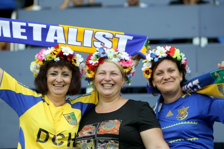 KHARKIV, UKRAINE -AUG 07:Fans and supporters of METALIST are cheering for their team during the UEFA Champions League soccer match METALIST vs PAOK at Metalist Arena on August 07,2013 in Kharkiv, Ukraine.のeditorial素材