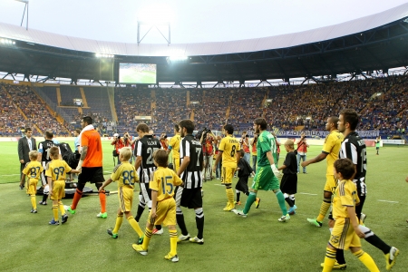 KHARKIV, UKRAINE -AUG 07:Players of PAOK and METALIST are entering the stadium before the UEFA Champions League soccer match METALIST vs PAOK at Metalist Arena on August 07,2013 in Kharkiv, Ukraine.のeditorial素材