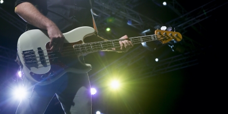 Abstract zoomed bass and performer hand on stage