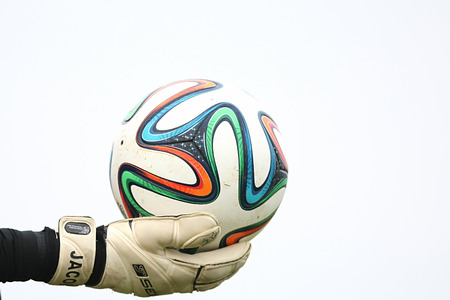 THESSALONIKI, GREECE - Jan 5 : Greek Superleague Brazuca (Mundial) balls on the goalkeeper's hand with gloves during the training of PAOK on January 5, 2014 in Thessaloniki, Greece.のeditorial素材