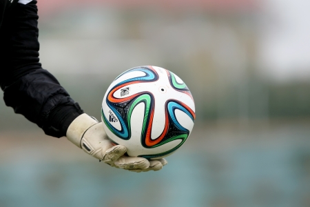 THESSALONIKI, GREECE - Jan 5 : Greek Superleague Brazuca (Mundial) balls on the goalkeeper's hand with gloves during the training of PAOK on January 5, 2014 in Thessaloniki, Greece.のeditorial素材