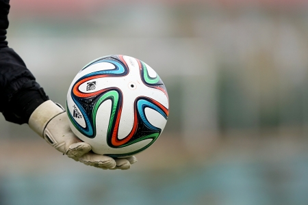 THESSALONIKI, GREECE - Jan 5 : Greek Superleague Brazuca (Mundial) balls on the goalkeeper's hand with gloves during the training of PAOK on January 5, 2014 in Thessaloniki, Greece.のeditorial素材