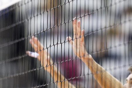 THESSALONIKI, GREECE  - FEBRUARY 15, 2014 :  Hands on net during the Hellenic Volleyball League game Paok vs Olympiacos at PAOK Sports Arena. Shallow dof.のeditorial素材