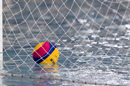 THESSALONIKI, GREECE MAR 5, 2014 : A water polo ball floating on the water in the net during the water polo game PAOK vs Nereas on March 5, 2014.のeditorial素材