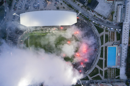 THESSALONIKI, GREECE APRIL 16, 2014 : Aerial view of the Toumba Stadium full of fans and supporters of PAOK who light flares during the Greek Cup Semi Final match PAOK vs Olympiacosのeditorial素材