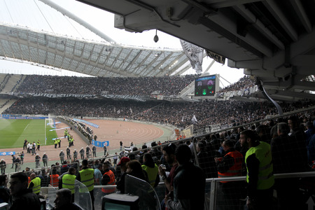 ATHENS, GREECE APRIL 26, 2014 : Wide view of the OAKA stadium and Paok fans and supporters who light flares during the Greek Cup Final match Paok vs Panathinaikosのeditorial素材
