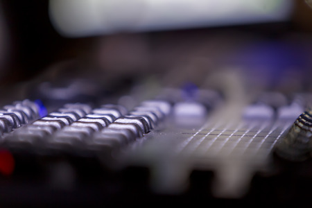 A mixing console, or audio mixer,shallow dof