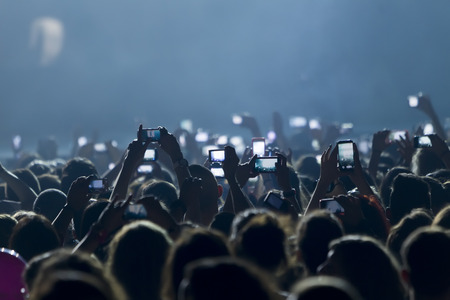 THESSALONIKI, GREECE, MAY 8 2014:People taking photographs with touch smart phone during a music concert live on stage for the Ace of Heart tour at Sports arena in Thessaloniki.のeditorial素材