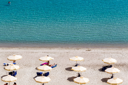 KALLITHEA, GREECE- MAY 27, 2014: Beach with tourists, sun beds and umbrellas. Expected to be the best sea travel destination. Top view of Kallithea, Halkidiki in Greece. .のeditorial素材