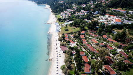 HALKIDIKI, GREECE- MAY 26, 2014: Top view of beach with tourists, sunbeds and umbrellas at a luxury hotel. Sea travel destination in Kallithea, Greeceのeditorial素材