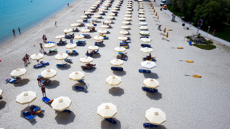 HALKIDIKI, GREECE- MAY 26, 2014: Beach with tourists, sunbeds and umbrellas. Beach of Kallithea, one of the most visited destinations in Greece. Top Viewのeditorial素材