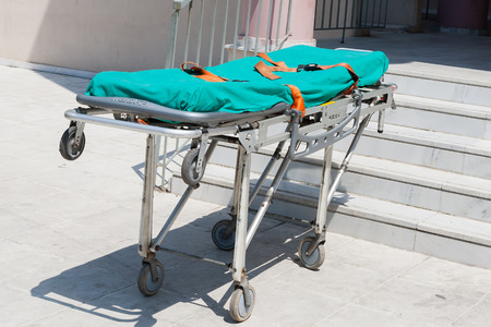 THESSALONIKI, GREECE- APRIL 24, 2013: Empty stretcher by the ambulance on the street during an earthquake exercise at 6th primary school in Thessaloniki, Greece.のeditorial素材
