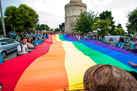 THESSALONIKI, GREECE- JUNE 21, 2014: Participants with the rainbow flag, the symbol of the gay rights movement, during the annual Gay Pride parade event in Thessaloniki, Greece.のeditorial素材