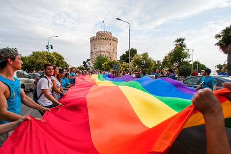 THESSALONIKI, GREECE- JUNE 21, 2014: Participants with the rainbow flag, the symbol of the gay rights movement, during the annual Gay Pride parade event in Thessaloniki, Greece.のeditorial素材