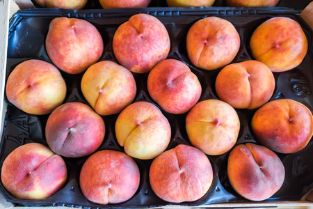 Freshly harvested peaches in a crate