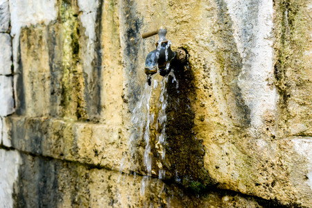 Old rusty water tap in villageの写真素材