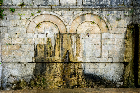 Old rusty water tap in villageの写真素材