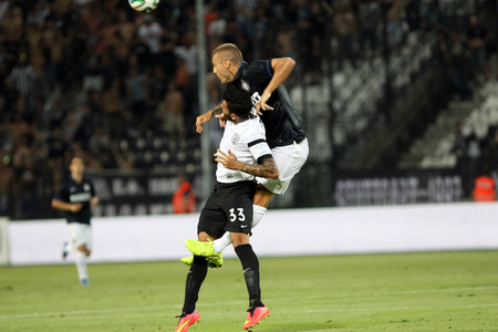 THESSALONIKI, GREECE- AUGUST 14, 2014 : Athanasiadis of Paok (L) in action with Vidic of Inter (R) during the friendly match Paok vs Inter.のeditorial素材