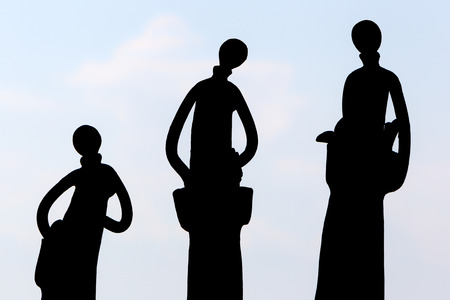 Silhouettes of Tall decorative metal dollsの写真素材
