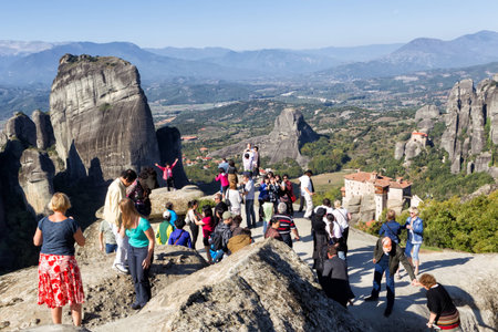 METEORA, GREECE - OCTOBER 12, 2014: Tourists taking pictures during their tour at Meteora, Greece.のeditorial素材
