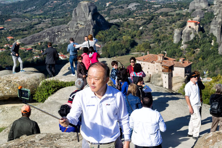 METEORA, GREECE - OCTOBER 12, 2014: Tourists taking pictures during their tour at Meteora, Greece.のeditorial素材