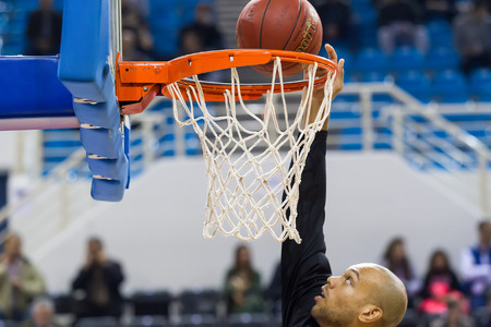THESSALONIKI, GREECE - NOV 12, 2014: Undefined player hands throwing a ball through the net prior to Eurocup game Paok vs Budocnostのeditorial素材