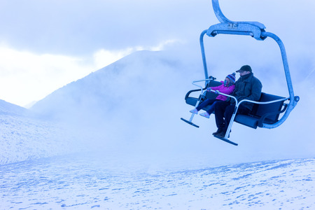 FALAKRO, GREECE - FEBRUARY 4, 2013: Unidentified skiers going up with a ski lift and enjoying the last ski ride of the season in the Falakro ski center, in Greece.のeditorial素材