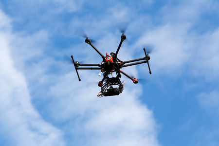 ATHENS, GREECE- DECEMBER 20, 2014: DJI S900 drone in flight with a mounted sony A7  Edition digital camera in Athens, Greece. DJI Industries produces unmanned aircraft for surveillanceのeditorial素材