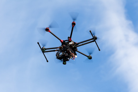 ATHENS, GREECE- DECEMBER 20, 2014: DJI S900 drone in flight with a mounted sony A7  Edition digital camera in Athens, Greece. DJI Industries produces unmanned aircraft for surveillanceのeditorial素材