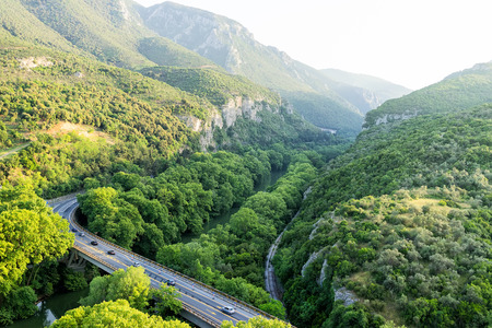 Aerial view of the bridge and the road over the river Pinios in the green valley of Tempe in Greeceの写真素材