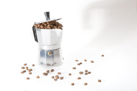 Classical Italian coffee maker pot filled with coffee beansの写真素材