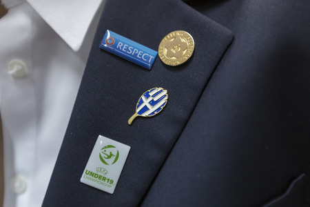KATERINI, GREECE, JUNE 9,2015: Close-up of the official Uefa Under19 Championship, Greece and respect pins.のeditorial素材