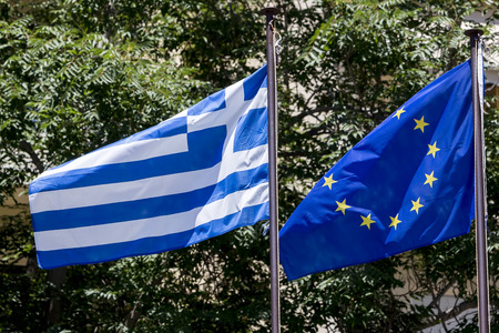 European Union flag and Greek flag, waving in the windの写真素材