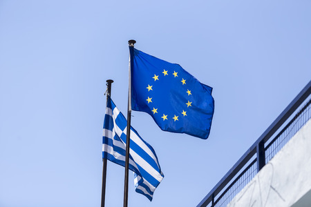 European Union flag and Greek flag, waving in the windの写真素材