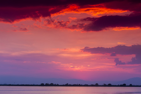 Beautiful sunset with clouds in the sky over oceanの写真素材