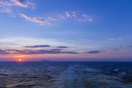 Beautiful sunset with clouds in the sky over oceanの写真素材