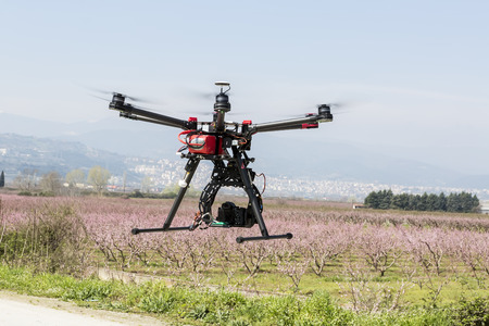 Athens, Greece, March 30, 2015: DJI S900 drone in flight with a mounted sony A7 Edition digital...