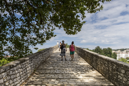 Women walking on the bridge looking at the View of Arachthos river of Arta city, Epirus Greeceの写真素材