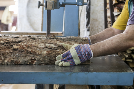 Thessaloniki, Greece, July 8, 2015: Craftsmen cut a piece of wood at a woodworking factory in Greece. Wood and furniture production plant, industrial factory with tools and objects.のeditorial素材