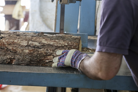 Thessaloniki, Greece, July 8, 2015: Craftsmen cut a piece of wood at a woodworking factory in Greece. Wood and furniture production plant, industrial factory with tools and objects.のeditorial素材